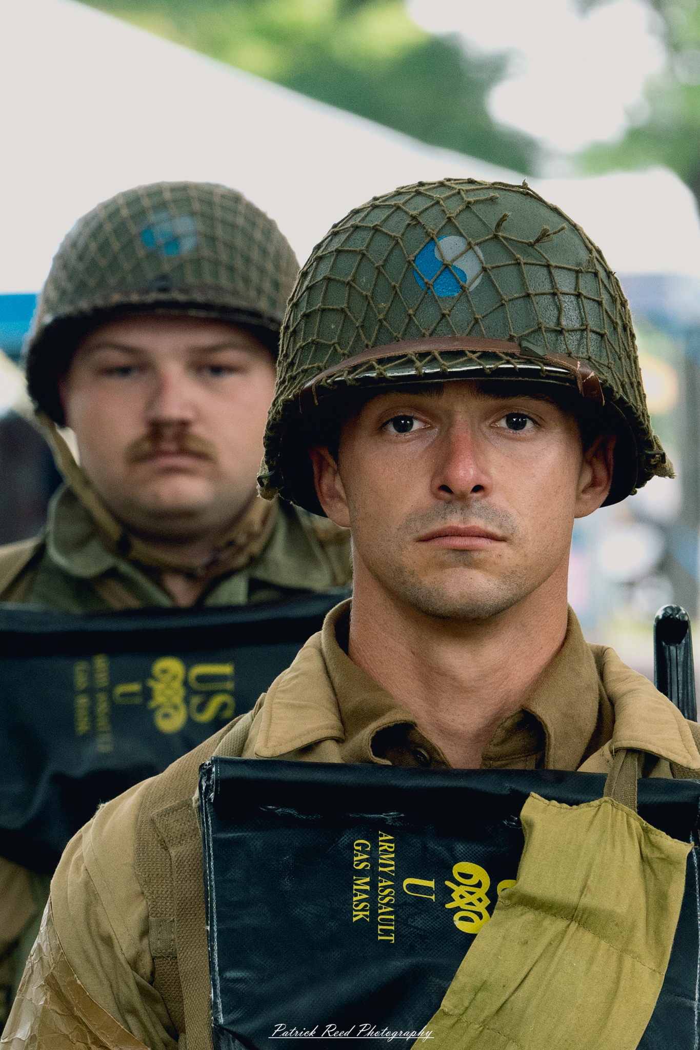 Two soldiers standing in formation, perfectly aligned and attentive. Their uniforms are neatly pressed, and their posture is disciplined, reflecting the unity and professionalism characteristic of military service during a formal event.